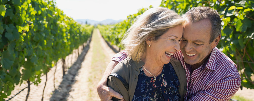 older couple outside in a vinyard