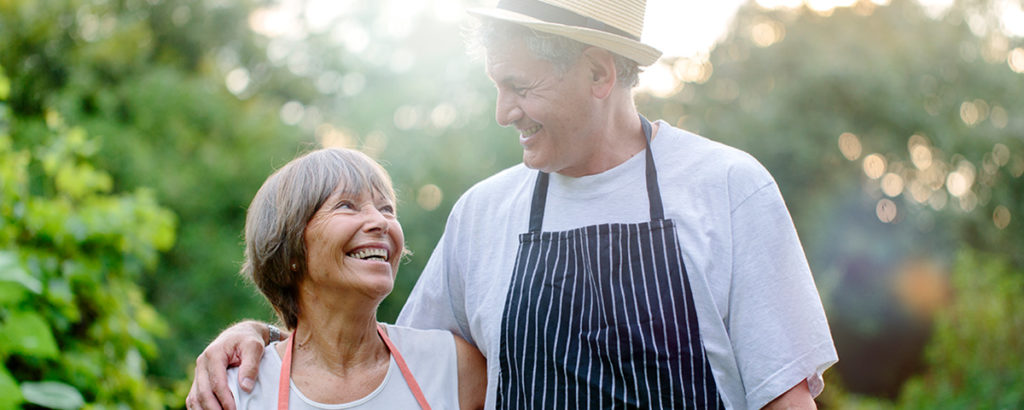 older couple outside cooking