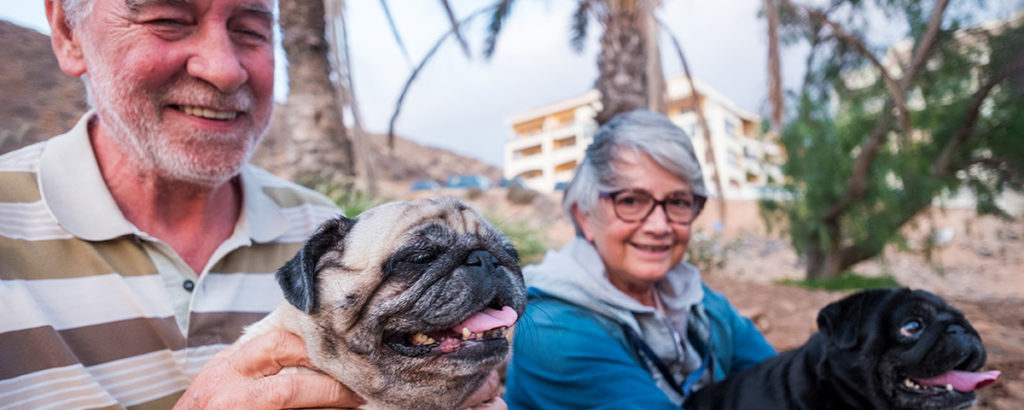 older couple outside with dog