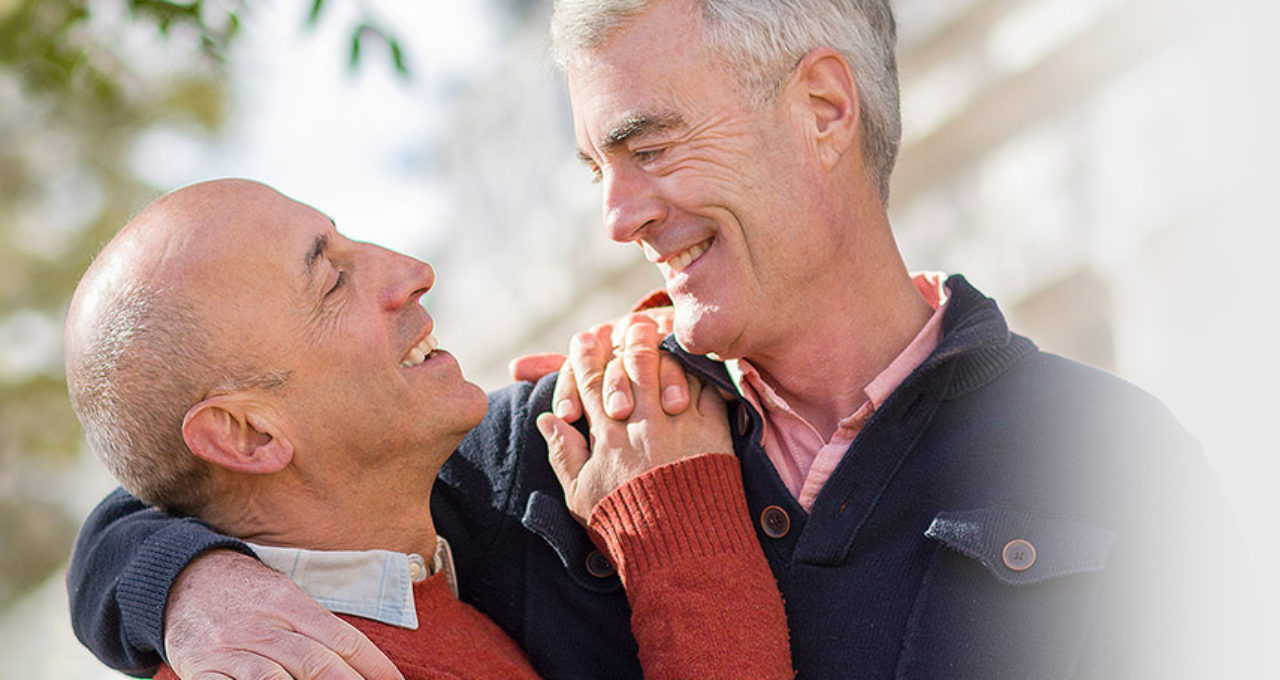 two older gay men hugging