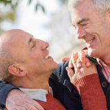 two older gay men hugging