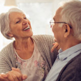 retired woman and man in the kitchen smiling