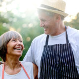 older couple outdoors BBQing