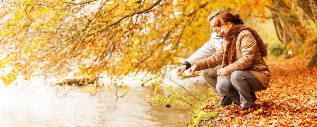 older man and woman in an autumn forest