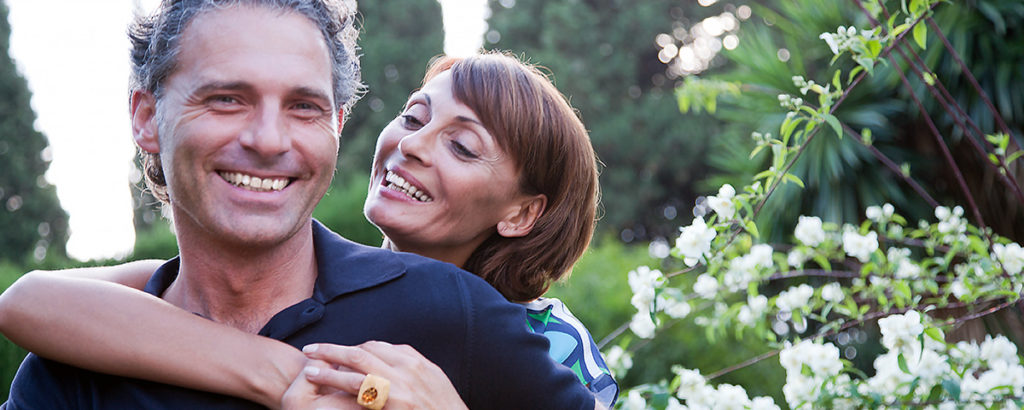 couple outside in garden hugging