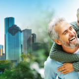 Image of a happy, smiling 50+ couple with a background of the city of the city of Houston.
