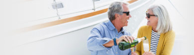 Mature couple enjoying a romantic date on a boat with champagne