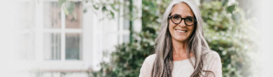 older attractive woman with glasses outside